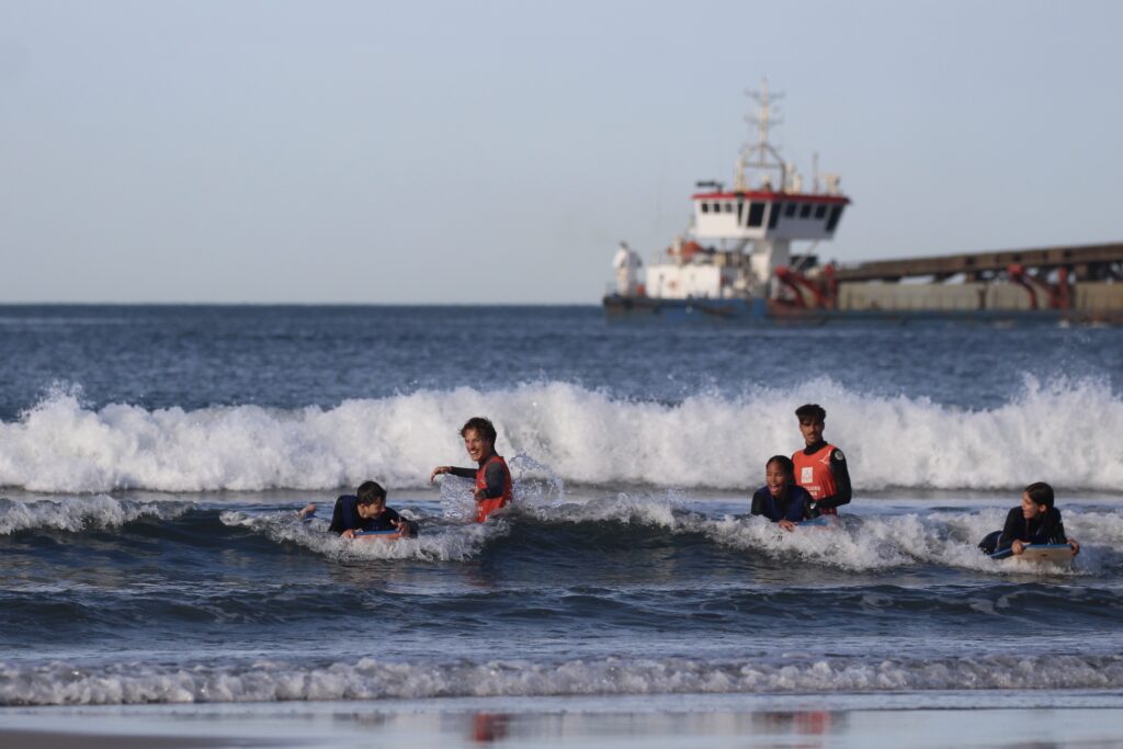 Surfcoaches and Students in the Water